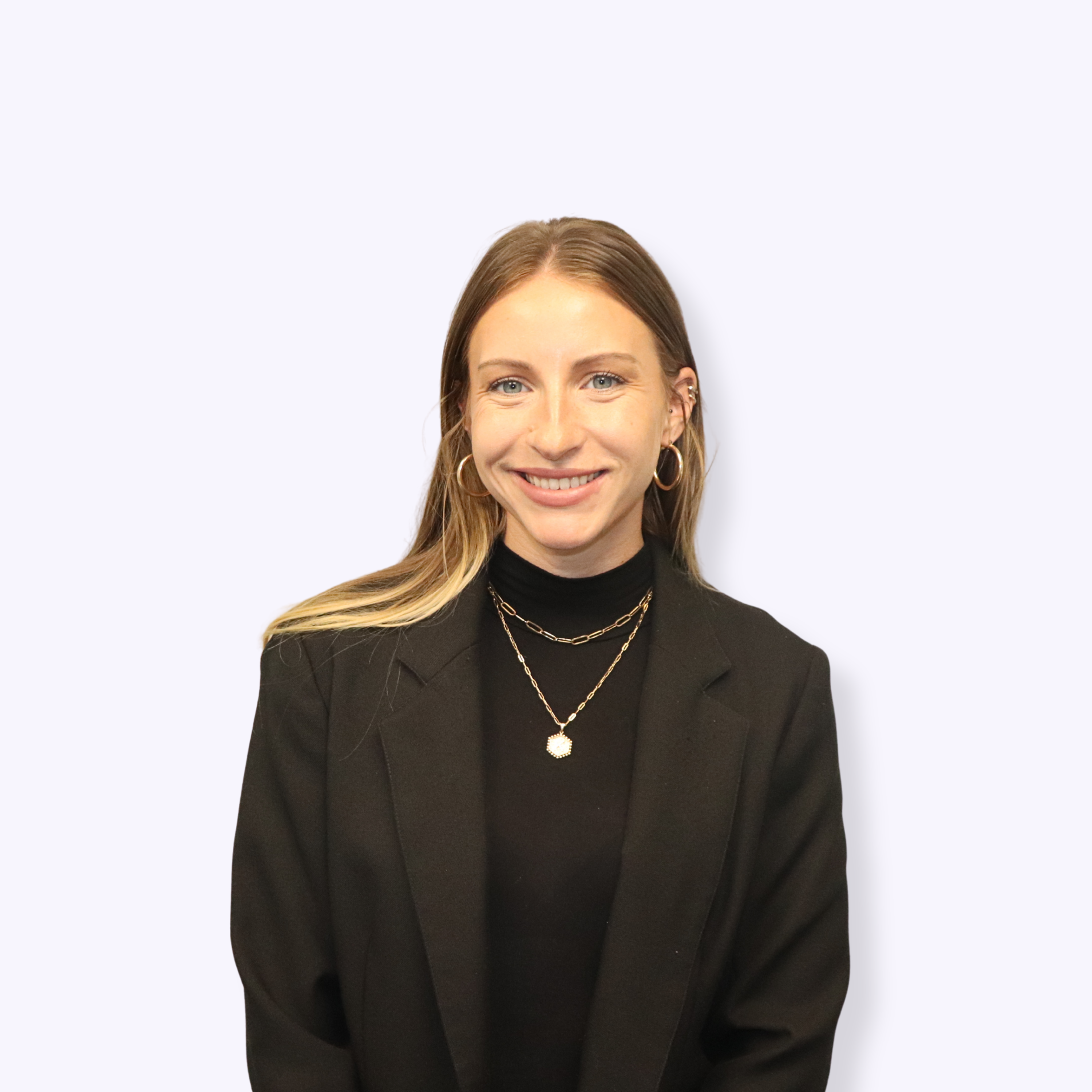 Headshot of a young woman with long hair wearing professional clothes.